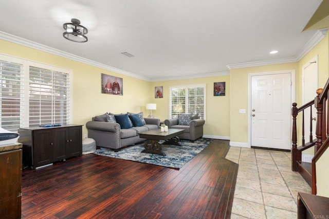living area featuring stairway, baseboards, ornamental molding, and light wood-style floors