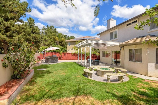 view of yard with a fenced backyard, a patio area, an outdoor fire pit, and a pergola