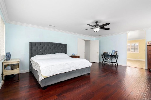 bedroom with baseboards, crown molding, wood finished floors, and visible vents