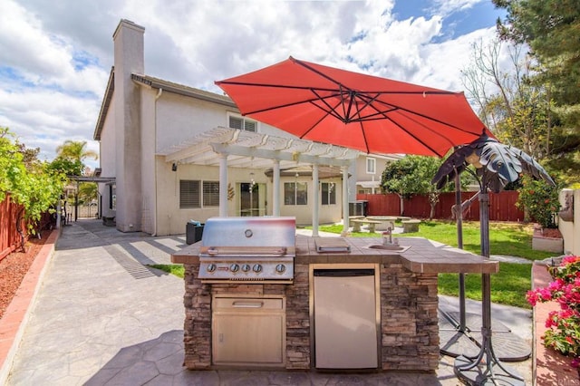 view of patio with a pergola, a fenced backyard, and area for grilling