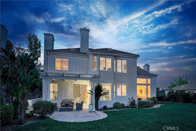 24932 Normans Way, Calabasas, CA 91302 - rear view of house featuring a chimney, a patio area, a lawn, and stucco siding