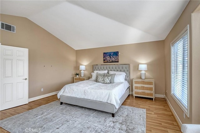 24932 Normans Way, Calabasas, CA 91302 - bedroom with vaulted ceiling, wood finished floors, and multiple windows
