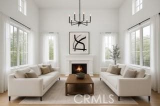 24932 Normans Way, Calabasas, CA 91302 - living room with a chandelier, a warm lit fireplace, and a towering ceiling