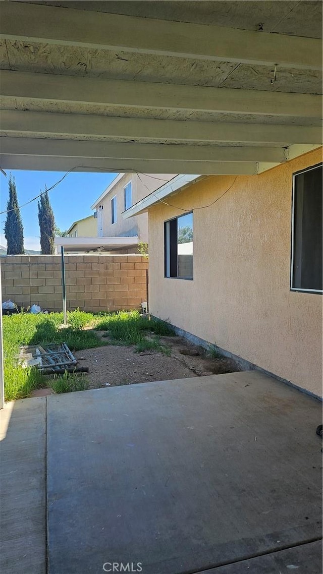 view of patio featuring fence