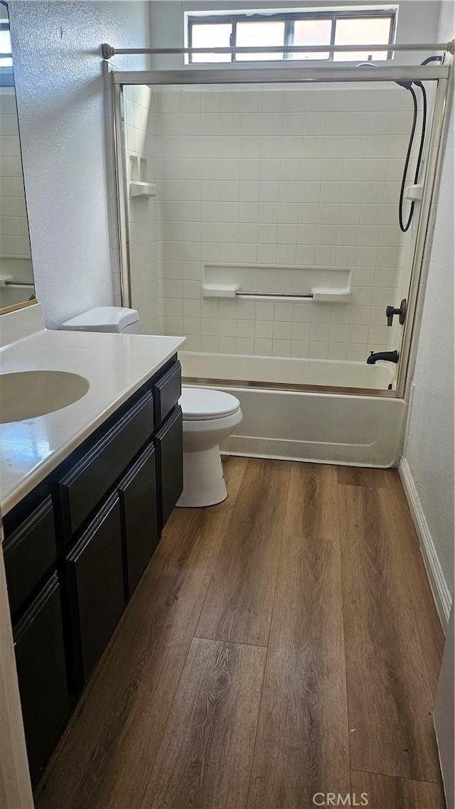 full bathroom with toilet, vanity, wood finished floors, and shower / bath combination