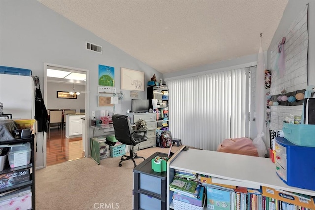 office space with carpet flooring, a textured ceiling, visible vents, and lofted ceiling