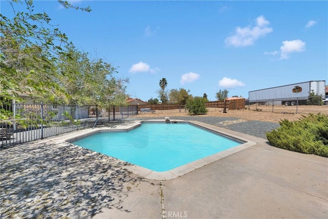 view of swimming pool with a fenced in pool, a fenced backyard, and a patio