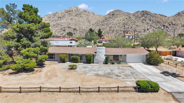 15895 Mandan Rd, Apple Valley, CA 92307 - view of front facade with concrete driveway, a mountain view, and a garage