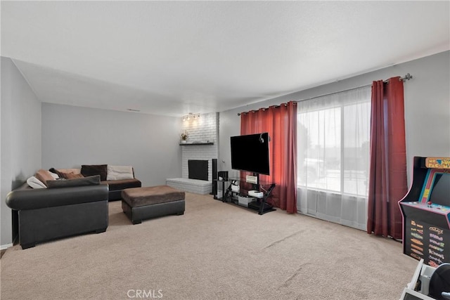 carpeted living area with a brick fireplace