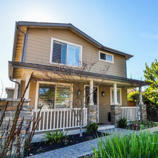 view of front of home featuring a porch and stone siding