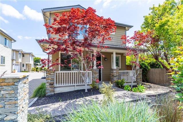 craftsman-style house with stone siding and covered porch