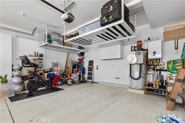 garage featuring a garage door opener, tankless water heater, and electric water heater