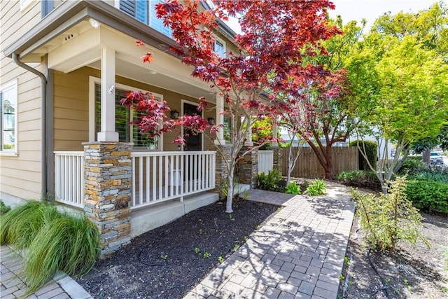exterior space with covered porch and fence