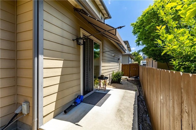 view of side of home featuring fence