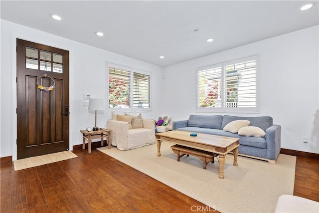living room featuring dark wood-style floors, recessed lighting, and baseboards