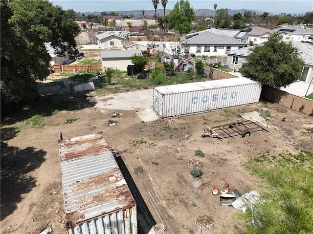 view of yard featuring a residential view, an outbuilding, and fence