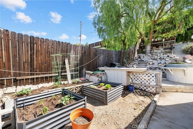 view of yard featuring a fenced backyard and a vegetable garden
