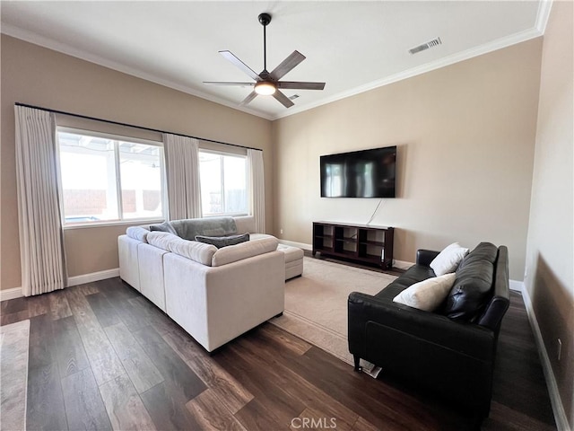 living room featuring ceiling fan, dark wood finished floors, ornamental molding, visible vents, and baseboards