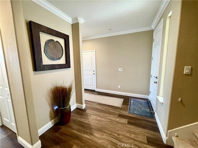 hall featuring wood finished floors, baseboards, and ornamental molding