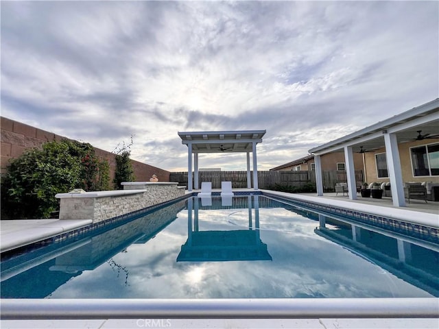 view of pool with a fenced in pool, a patio, a fenced backyard, and a ceiling fan