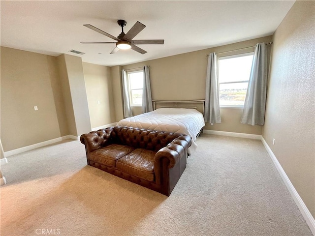 carpeted bedroom featuring visible vents, baseboards, and a ceiling fan