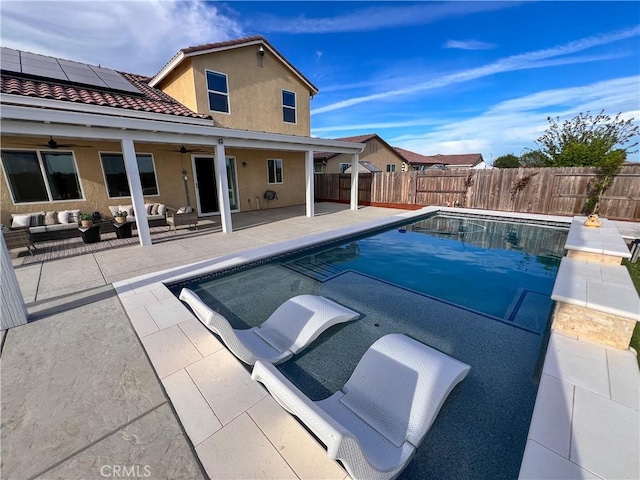 view of swimming pool featuring a fenced in pool, a patio, outdoor lounge area, a fenced backyard, and ceiling fan