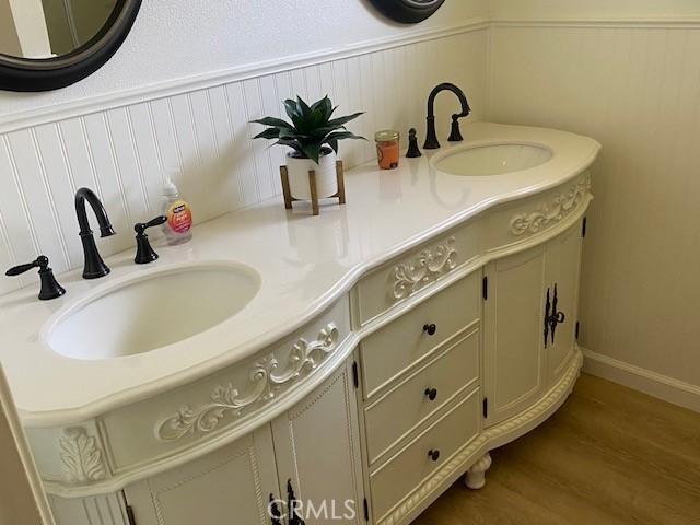 bathroom featuring vanity and wood finished floors