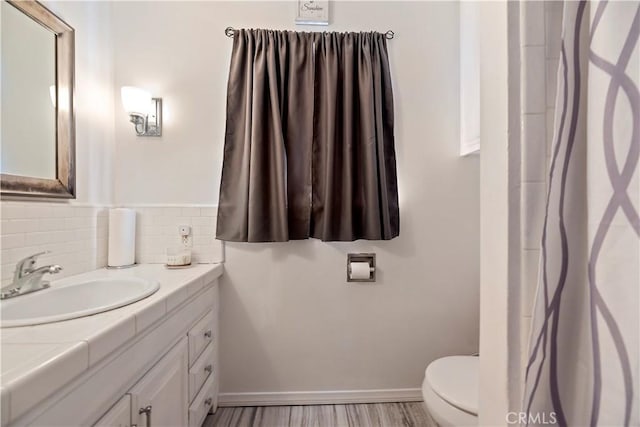22432 Van Buren St, Grand Terrace, CA 92313 - bathroom with vanity, toilet, tasteful backsplash, and baseboards