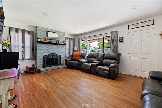 22432 Van Buren St, Grand Terrace, CA 92313 - living room with a brick fireplace, recessed lighting, and wood finished floors
