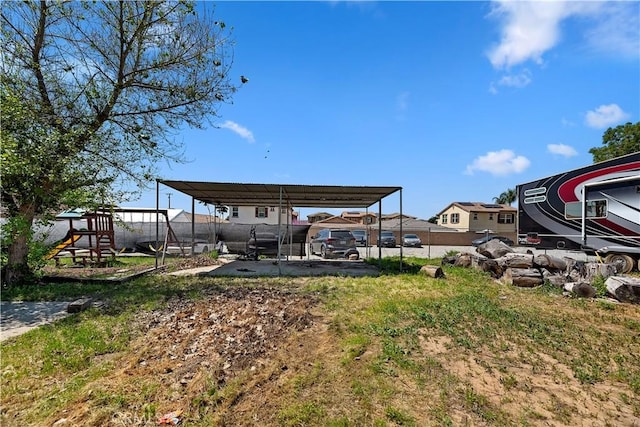 22432 Van Buren St, Grand Terrace, CA 92313 - view of yard with a detached carport, a playground, and fence