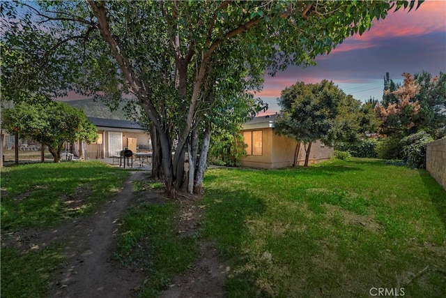22432 Van Buren St, Grand Terrace, CA 92313 - yard at dusk featuring a patio area and fence