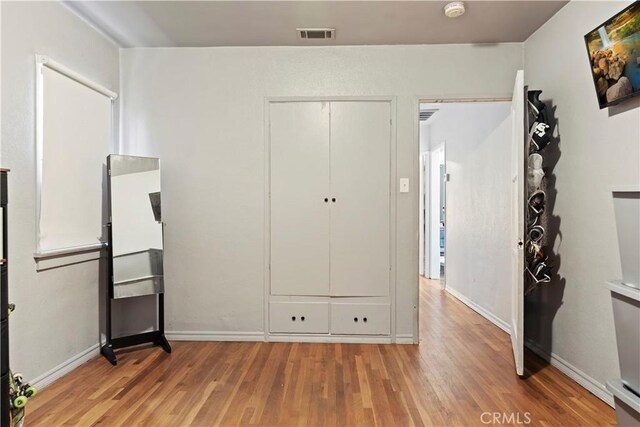 22432 Van Buren St, Grand Terrace, CA 92313 - unfurnished bedroom featuring baseboards, visible vents, and light wood-type flooring