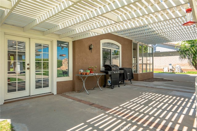 view of patio / terrace with a pergola, grilling area, fence, and french doors