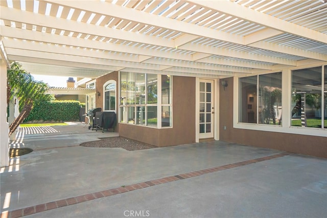 view of patio featuring area for grilling and a pergola