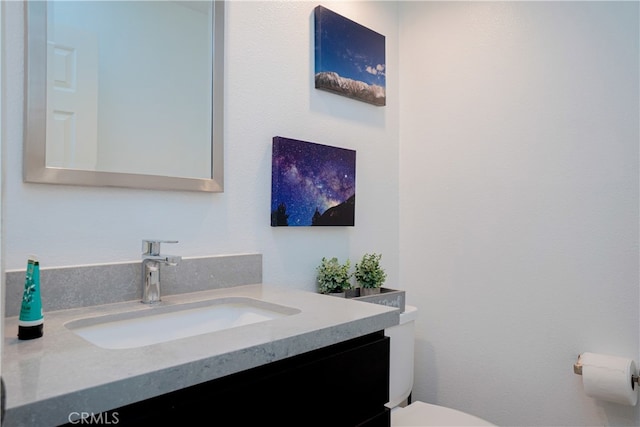 bathroom with toilet and vanity