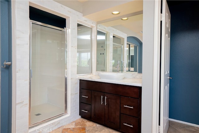 full bathroom with recessed lighting, vanity, and a stall shower