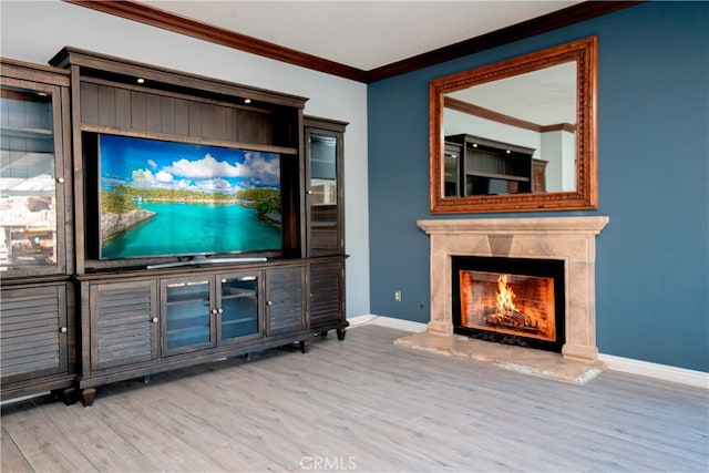unfurnished living room featuring crown molding, wood finished floors, a high end fireplace, and baseboards
