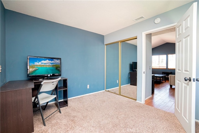 office area with carpet, visible vents, baseboards, and vaulted ceiling