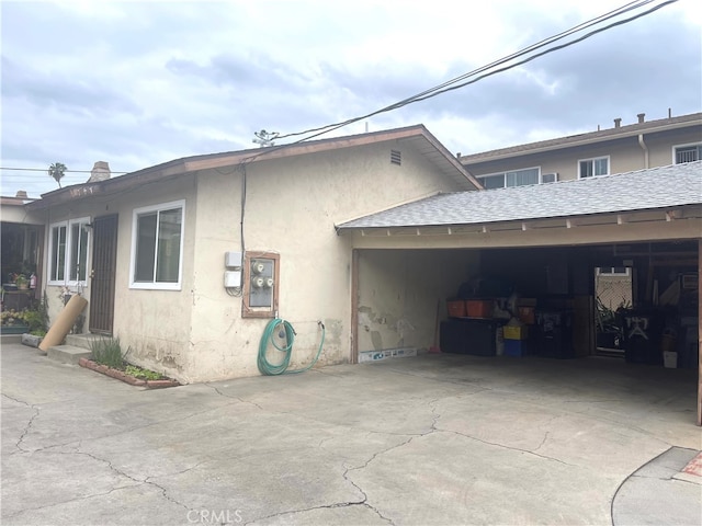 745 S Chapel Ave, Alhambra, CA 91801 - view of side of property featuring entry steps, a shingled roof, concrete driveway, and stucco siding