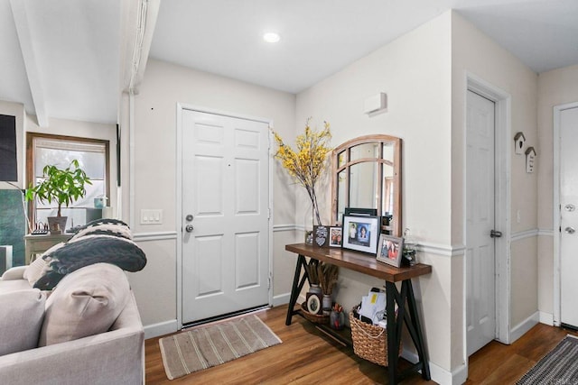 foyer entrance featuring wood finished floors and baseboards