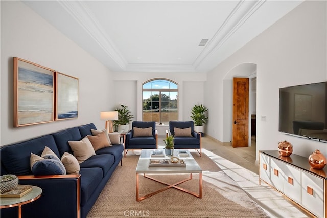 living room with visible vents, a raised ceiling, ornamental molding, and arched walkways