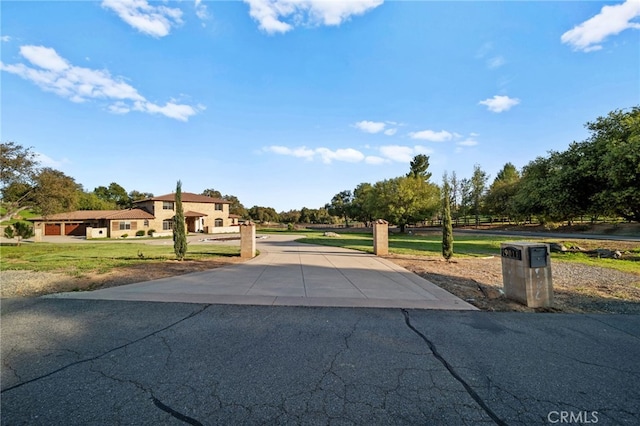 view of road featuring concrete driveway