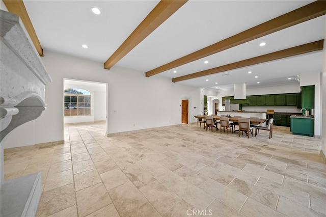 living room with beamed ceiling, recessed lighting, and stone tile flooring