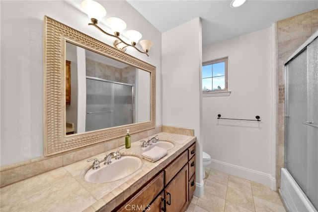 full bath featuring double vanity, an enclosed shower, toilet, and a sink