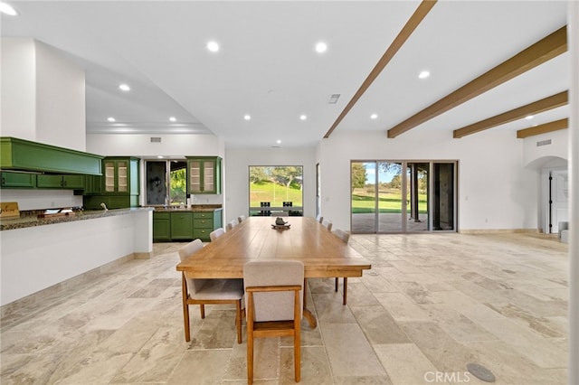 dining space featuring recessed lighting, beam ceiling, stone finish flooring, visible vents, and arched walkways