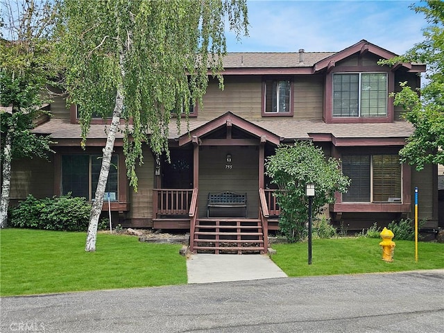 755 Cienega Rd Unit B, Big Bear Lake, CA 92315 - view of front of house featuring a shingled roof, a front lawn, and covered porch