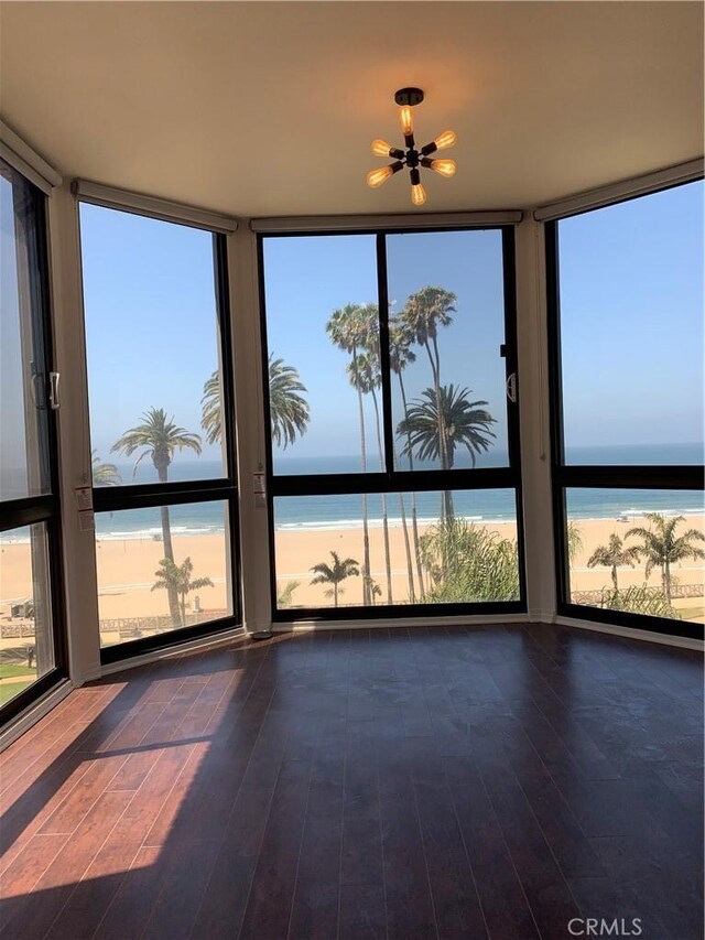 unfurnished sunroom featuring a water view and a healthy amount of sunlight