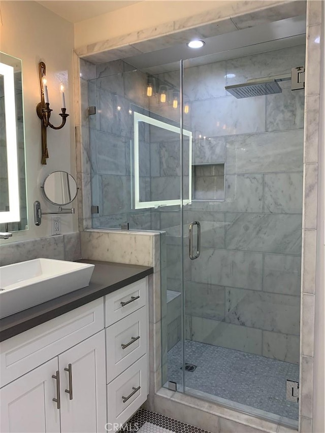 full bathroom with recessed lighting, a shower stall, and vanity