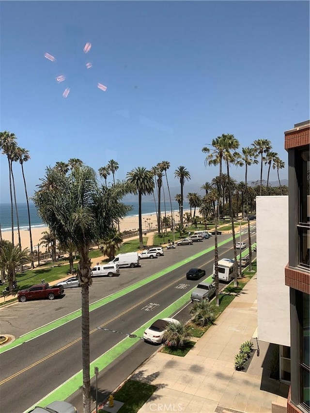 surrounding community with a view of the beach and a water view