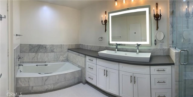 bathroom with a bath, vanity, tile patterned floors, and a stall shower